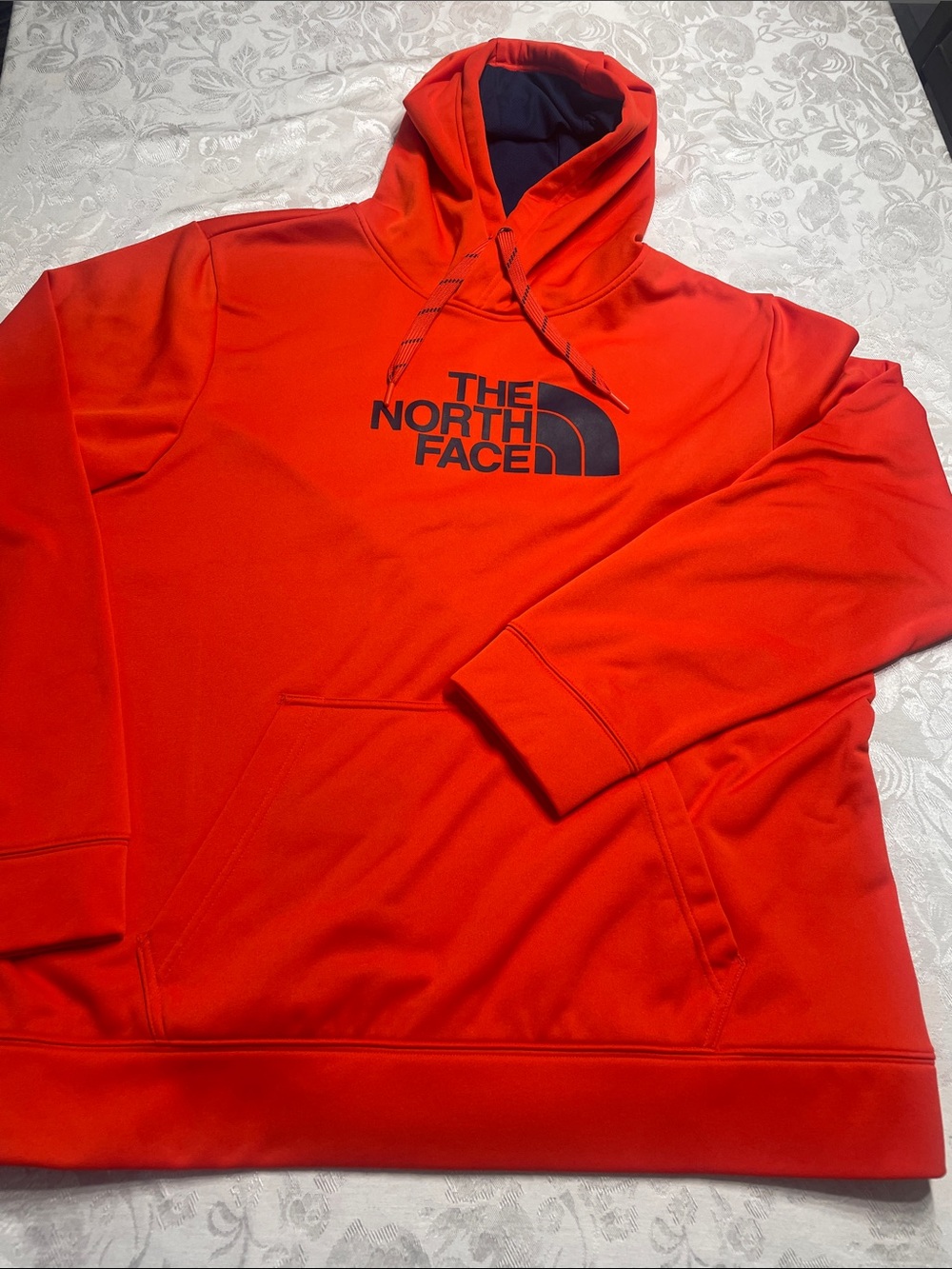 The North Face Men’s Orange Pullover Hoodie with Black Logo Size XL. Preowned.
